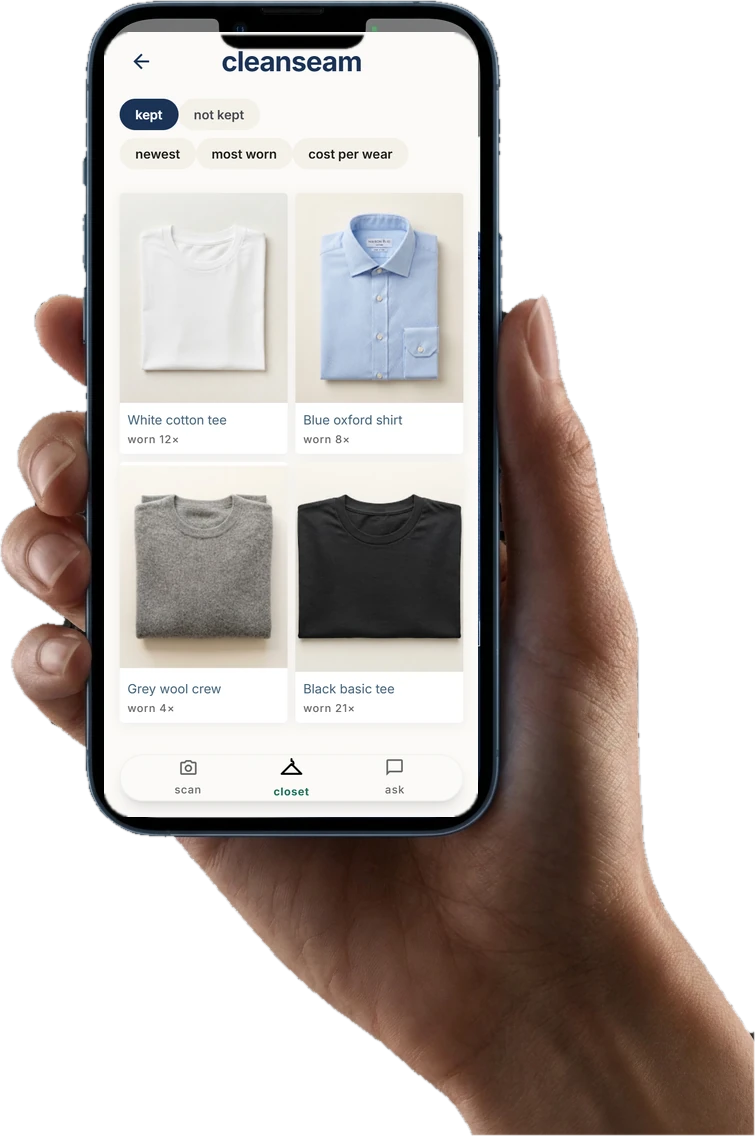 A hand holding a phone with the cleanseam camera open on a denim tee.